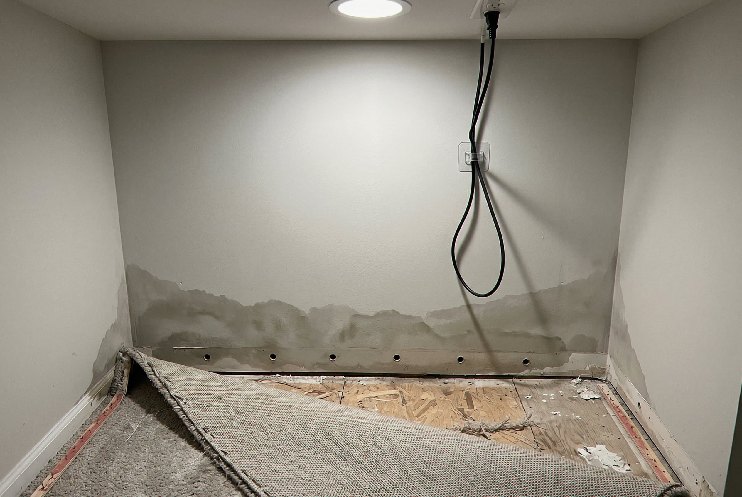 Water-damaged wall studs and framing exposed
